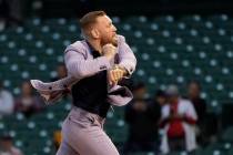 MMA fighter Conor McGregor throws out a ceremonial first pitch before a baseball game between t ...
