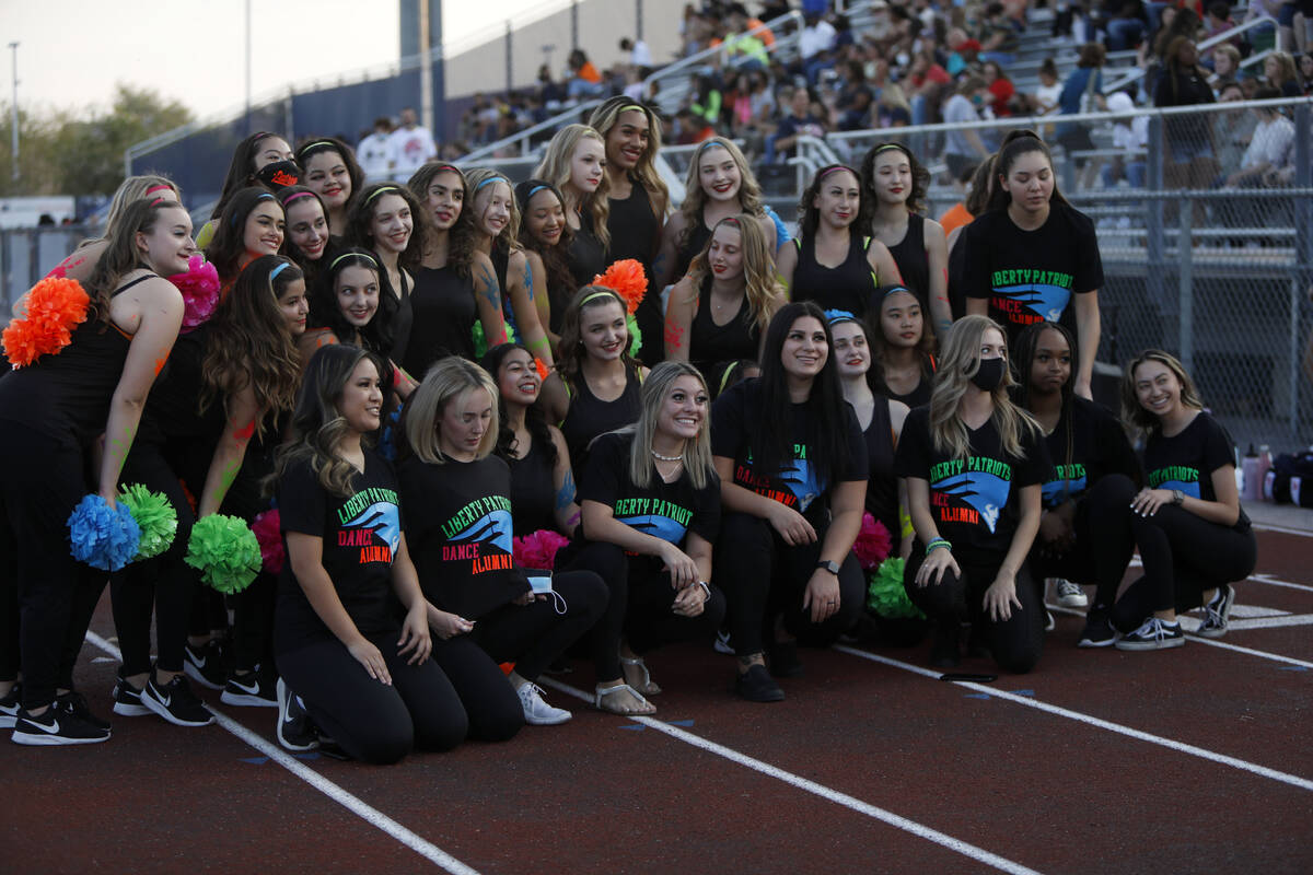Liberty High School's dance team members pose for a photo before a football game against Faith ...