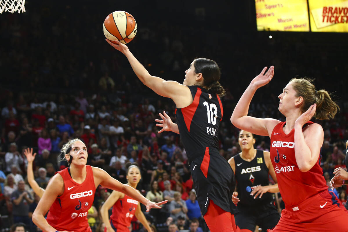 Las Vegas Aces' Kelsey Plum (10) goes to the basket past Washington Mystics' Emma Meesseman dur ...