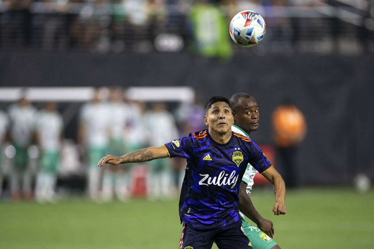 Seattle Sounders forward Raul Ruidiaz (9) and Leon defender Jaine Barreiro (21) eye the ball du ...
