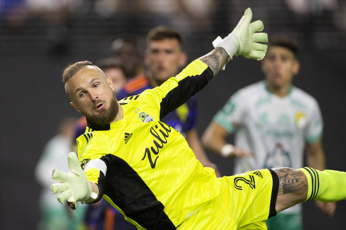 Seattle Sounders goalkeeper Stefan Frei (24) dives to save a shot by Club Len during the League ...