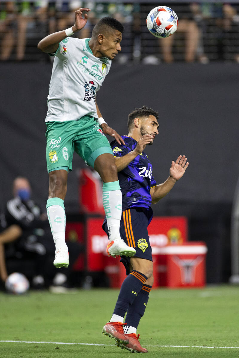 Leon defender William Tesillo (6) and Seattle Sounders midfielder Cristian Roldan (7) jump for ...