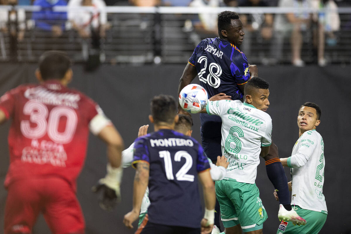 Seattle Sounders defender Yeimar Gomez (28) and Leon defender William Tesillo (6) fall down fro ...