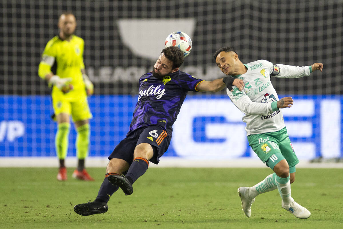 Seattle Sounders midfielder Joao Paulo (6) and Leon midfielder Luis Montes (10) attempt to head ...