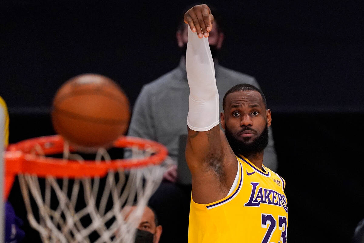 Los Angeles Lakers guardant  LeBron James shoots during the archetypal  fractional  of an NBA hoops  crippled  ...