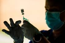 this Sept. 14, 2021, file photo, a syringe is prepared with the Pfizer COVID-19 vaccine at a cl ...