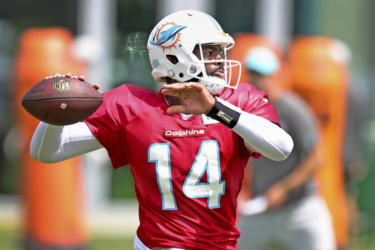 Miami Dolphins quarterback Jacoby Brissett (14) throws during NFL football practice, Wednesday, ...