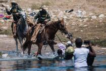U.S. Customs and Border Protection mounted officers attempt to contain migrants as they cross t ...
