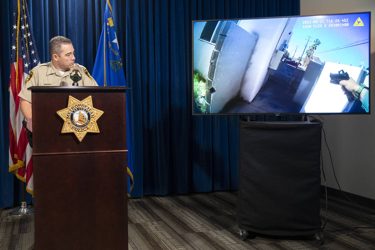 Assistant Sheriff Andrew Walsh shows body camera footage from the scene of a police shooting on ...