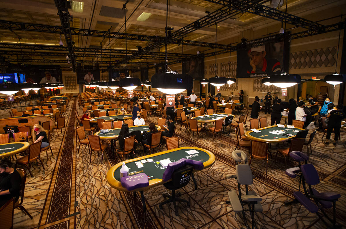 Massage therapists gather near poker tables as they complete paperwork ahead of the World Serie ...
