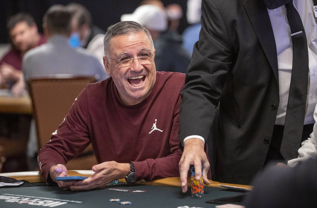 Professional poker player Eli Elezra plays laughs as chips are counted during the $25,000 buy-i ...