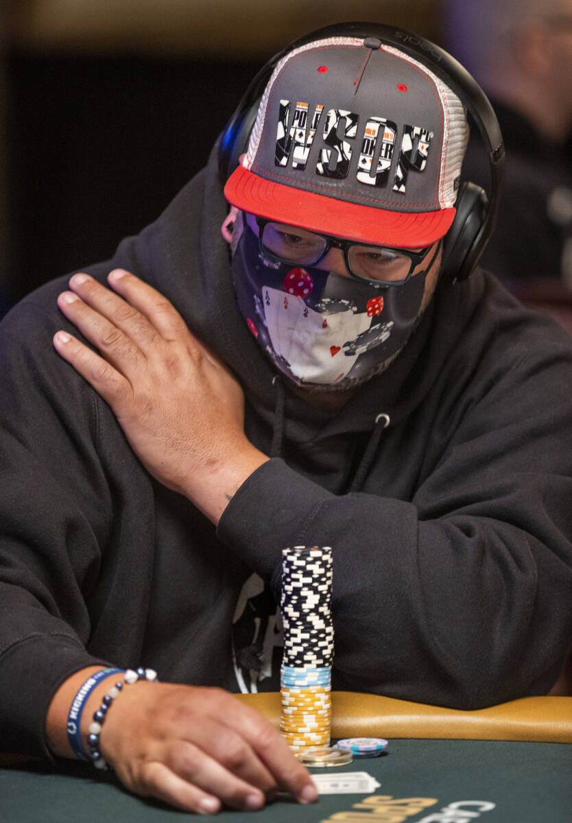 A player is dressed in poker hat and mask during a $500 casino employees event on the first day ...
