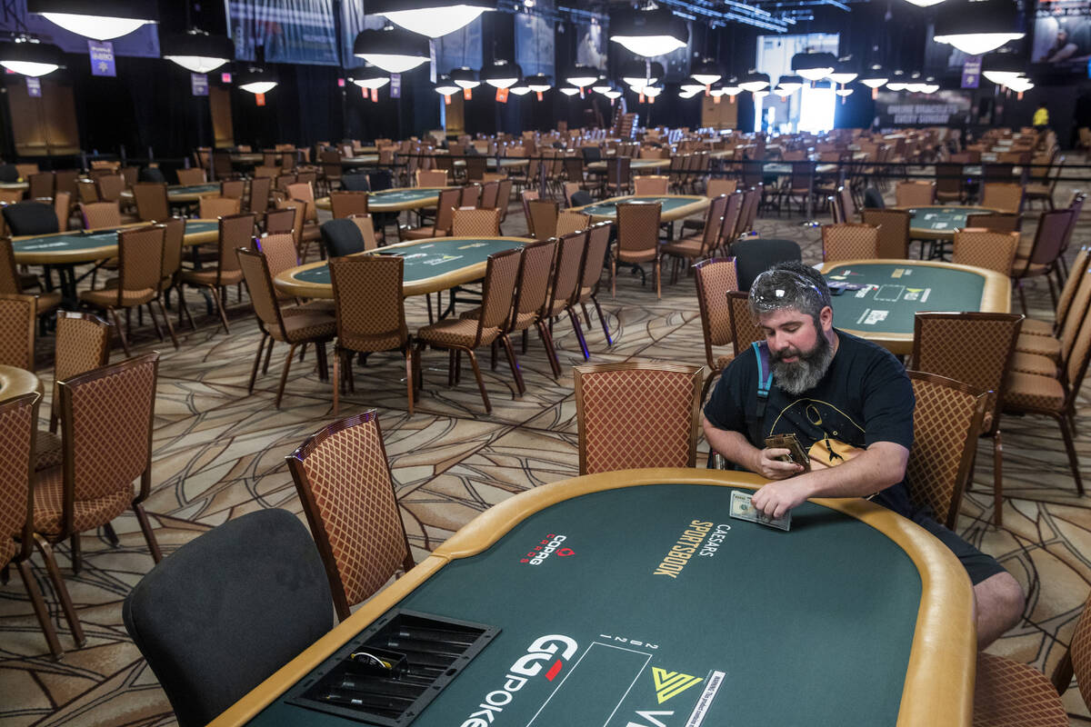 Player Ryan Leng of Las Vegas readies some cash to assist other players on the first day of the ...