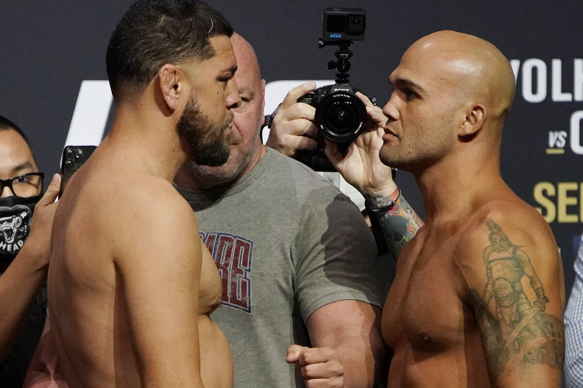 Nick Diaz, left, and Robbie Lawler pose during a ceremonial weigh-in for a UFC 266 mixed martia ...