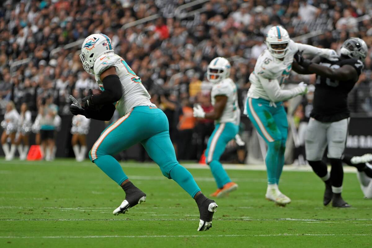 Miami Dolphins middle linebacker Elandon Roberts (52) makes an interception against the Las Veg ...