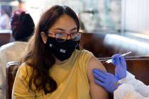 Stephanie Reyes, of Las Vegas, receives the Pfizer COVID-19 vaccination during a pop-up vaccina ...