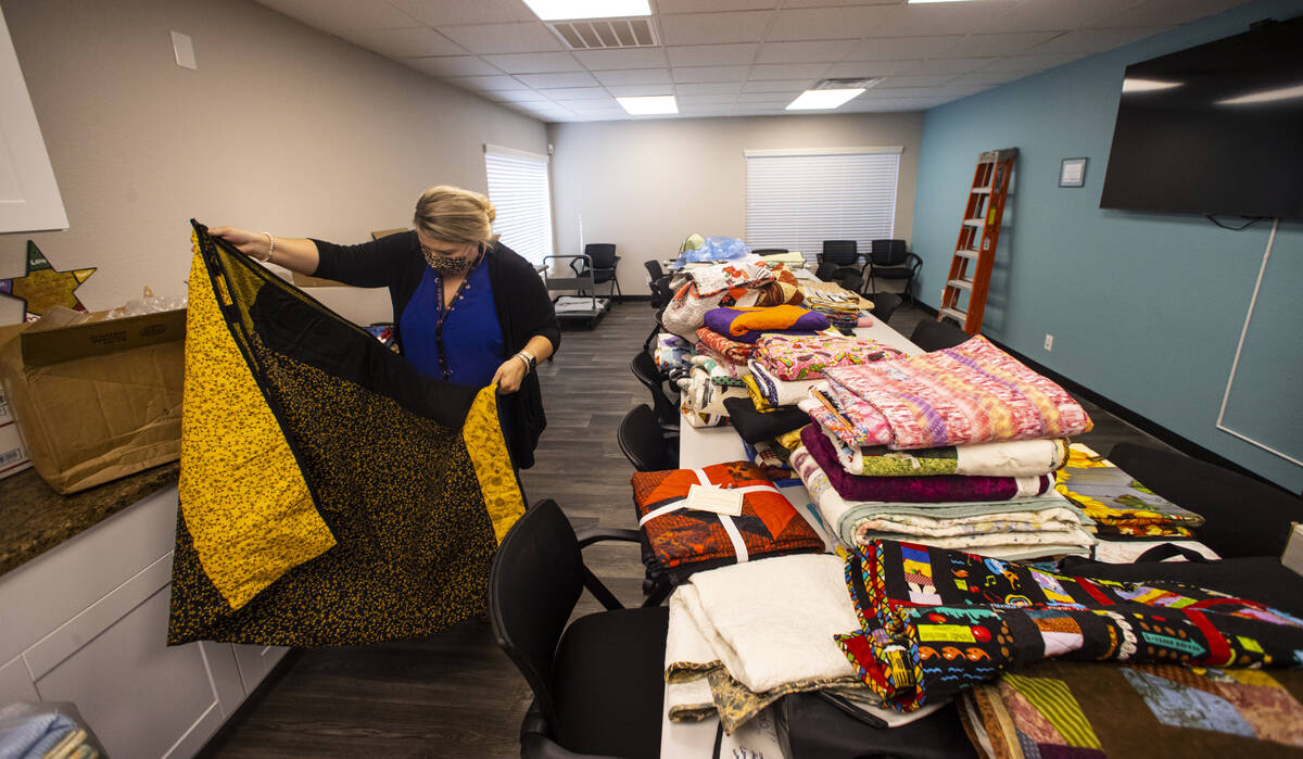Lorea Arostegui, a victim advocate of the Vegas Strong Resiliency Center, looks through donated ...