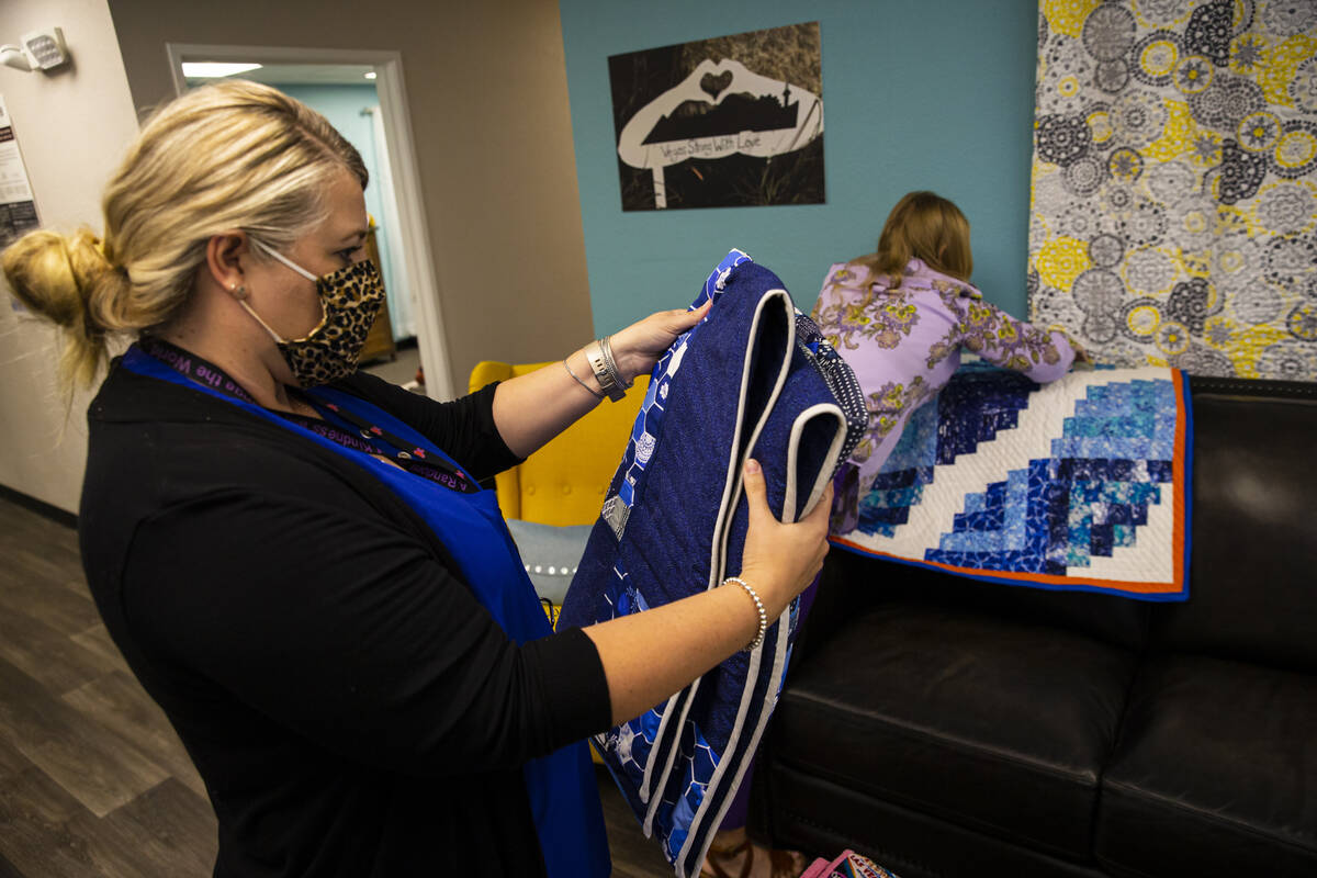 Lorea Arostegui, a victim advocate of the Vegas Strong Resiliency Center, looks through donated ...