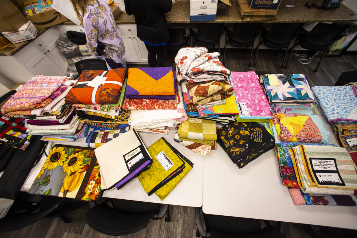 Donated quilts that will be given away to survivors, relatives and first responders affected in ...