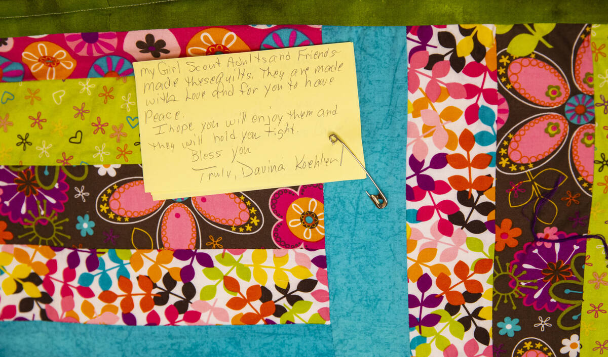 A donated quilt is seen from a group of Girl Scouts that will be given away to survivors, rela ...