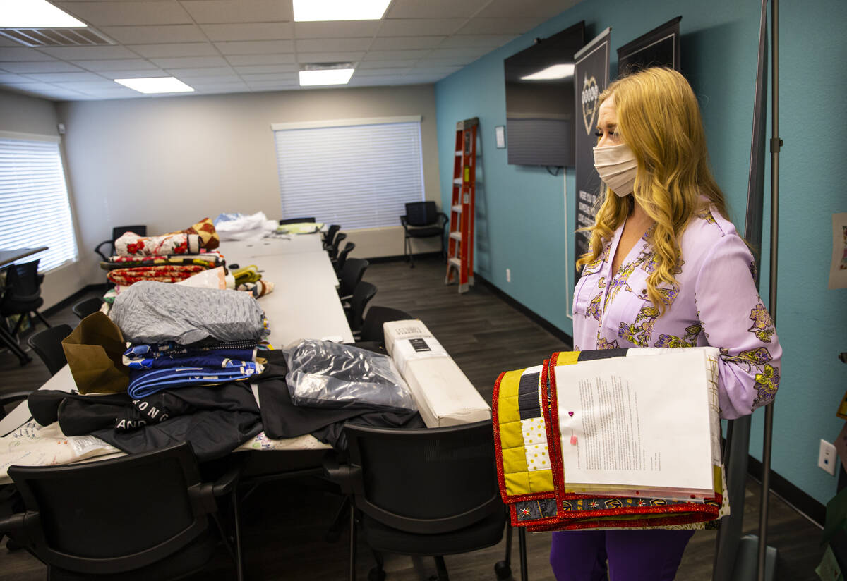Tennille Pereira, director of the Vegas Strong Resiliency Center, looks holds a Golden Knights- ...