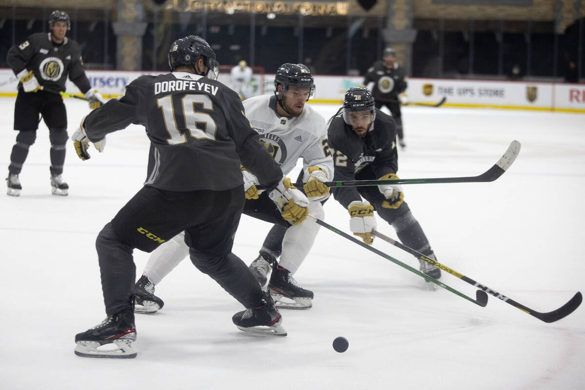 Golden Knights forward Lucas Elvenes (25) passes as forwards Pavel Dorofeyev (16) and Gage Quin ...