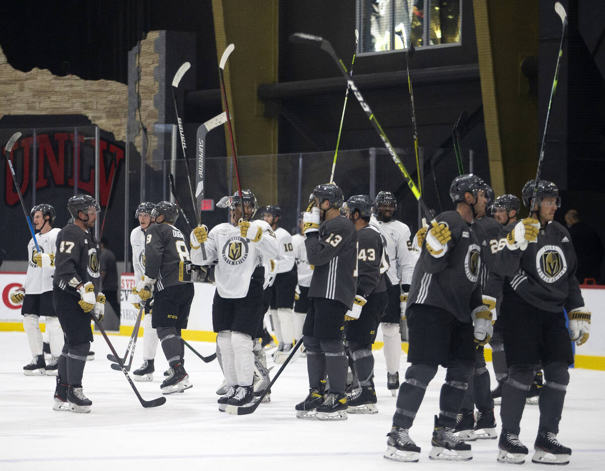Golden Knights players throw up their sticks for the fans after an NHL hockey training camp scr ...