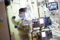 Ann Enderle R.N. attends to a COVID-19 patient in the Medical Intensive care unit (MICU) at St. ...