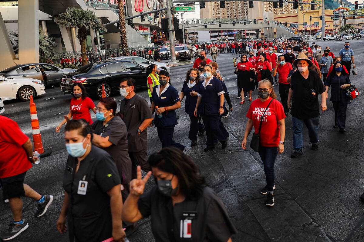 Members and supporters of the Culinary Workers Union Local 226 march the Strip to bring attenti ...