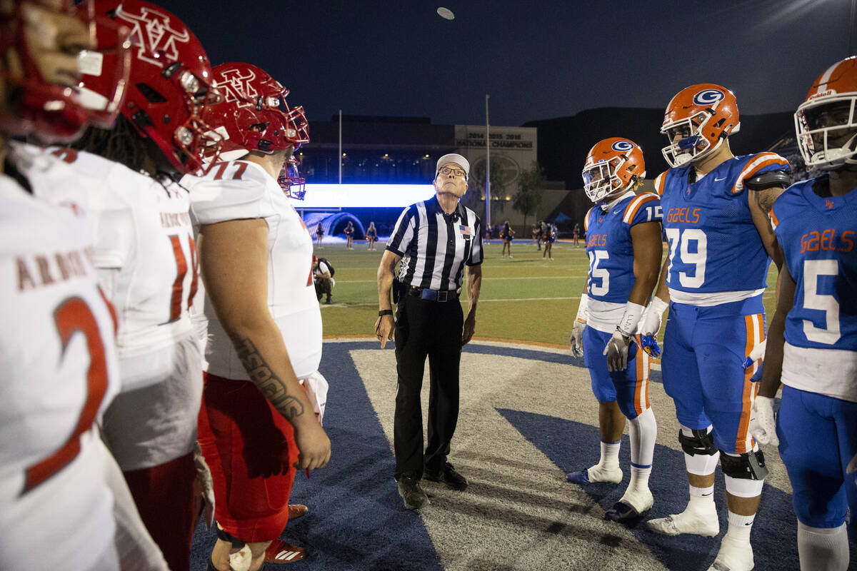 Arbor View and Bishop Gorman players participate in the pregame coin toss before the start of t ...