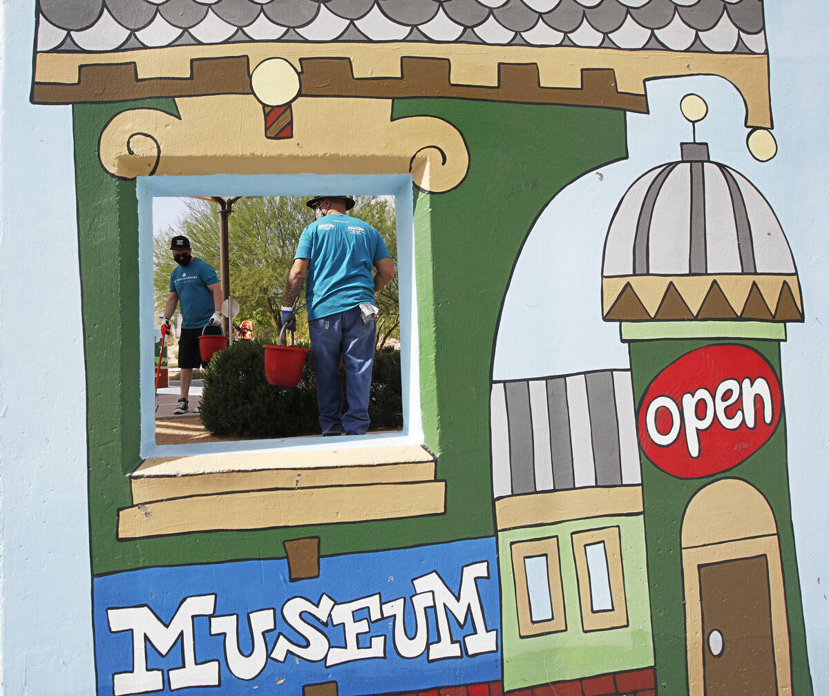 Steven Nelson, left, and Erik Delmar both from The Venetian Resort, pick trash during a park cl ...
