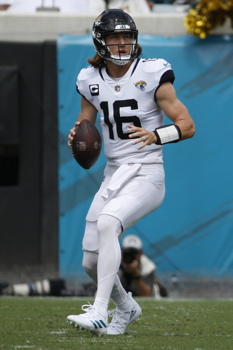 Jacksonville Jaguars quarterback Trevor Lawrence (16) looks for a receiver against the Denver B ...