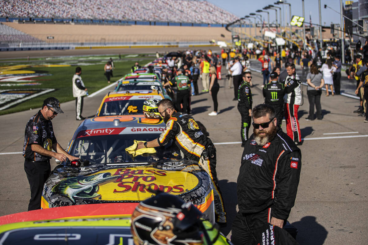Crews make last minute adjustments to their cars before the start of the Alsco Uniforms 302 NAS ...
