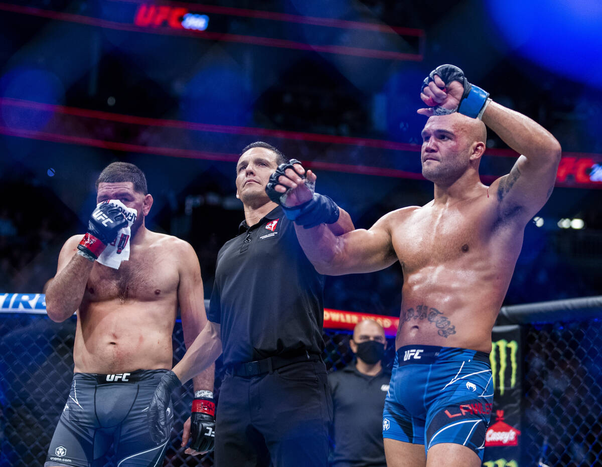 Robbie Lawler, right, and Nick Diaz after Lawler wins their welterweight fight in UFC 266 at T- ...