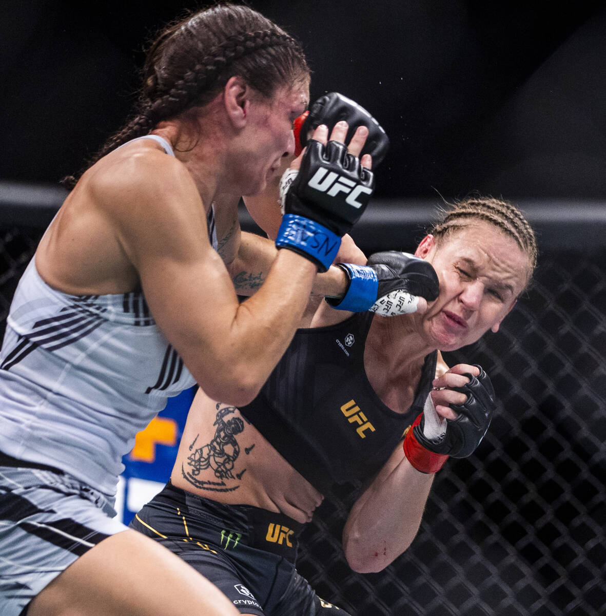 Lauren Murphy, left, connects on Valentina Shevchenko in the first round of their women's flywe ...