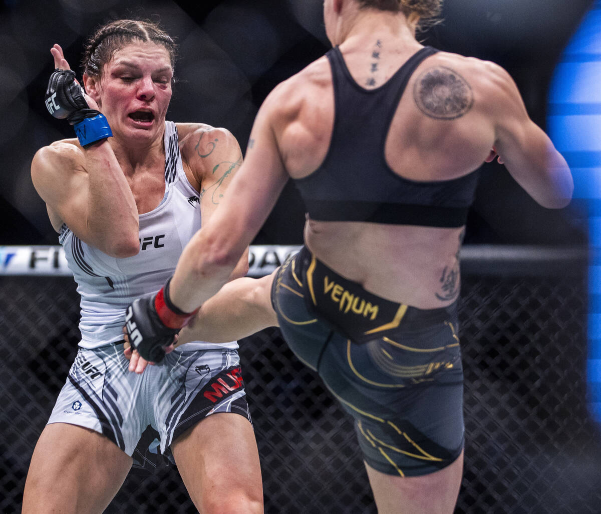 Lauren Murphy, left, is kicked by Valentina Shevchenko in the second round of their women's fly ...