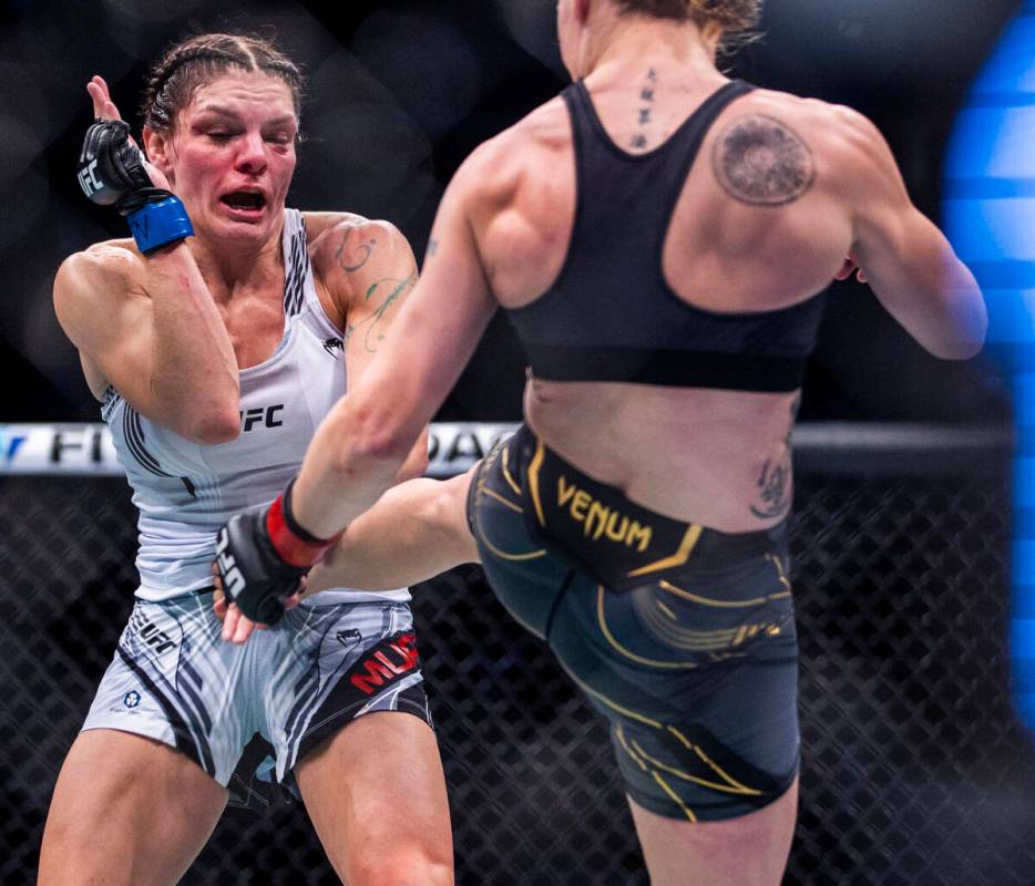 Lauren Murphy, left, is kicked by Valentina Shevchenko in the second round of their women's fly ...