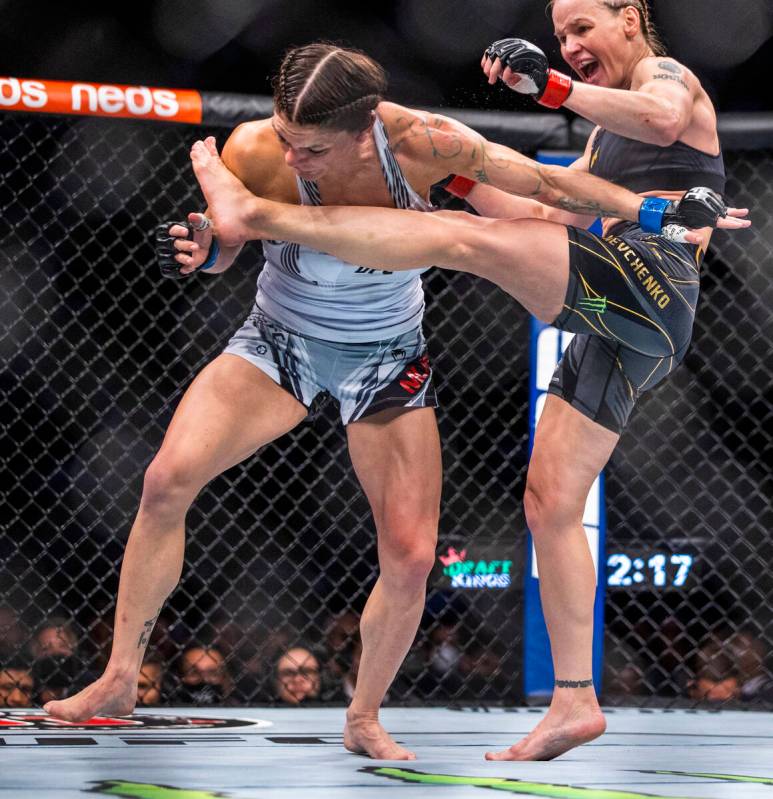 Lauren Murphy, left, is kicked by Valentina Shevchenko in the fourth round of their women's fly ...