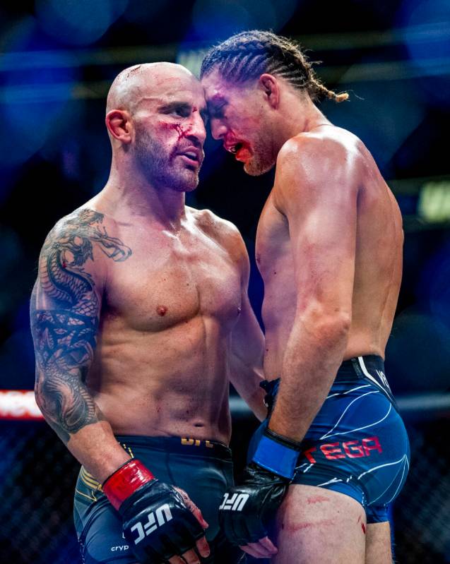 Alexander Volkanovski, left, and Brian Ortega come together following the fifth round of their ...