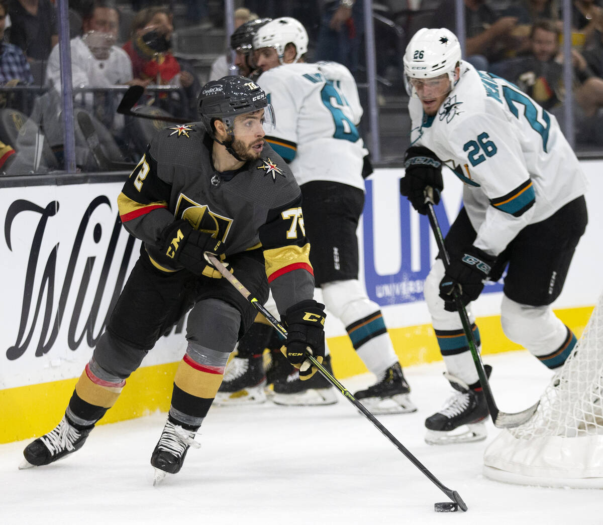 Golden Knights forward Gage Quinney (72) skates with the puck with Sharks center Jasper Weather ...
