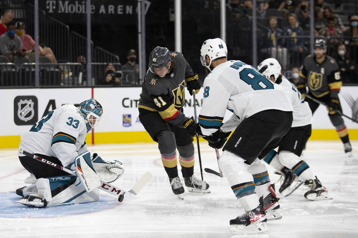 Sharks goaltender Adin Hill (33) saves a shot by Golden Knights forward Nolan Patrick (41) as S ...