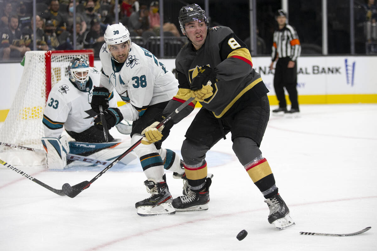 Golden Knights forward Jack Dugan (8) receives a pass as Sharks defenseman Mario Ferraro (38) g ...