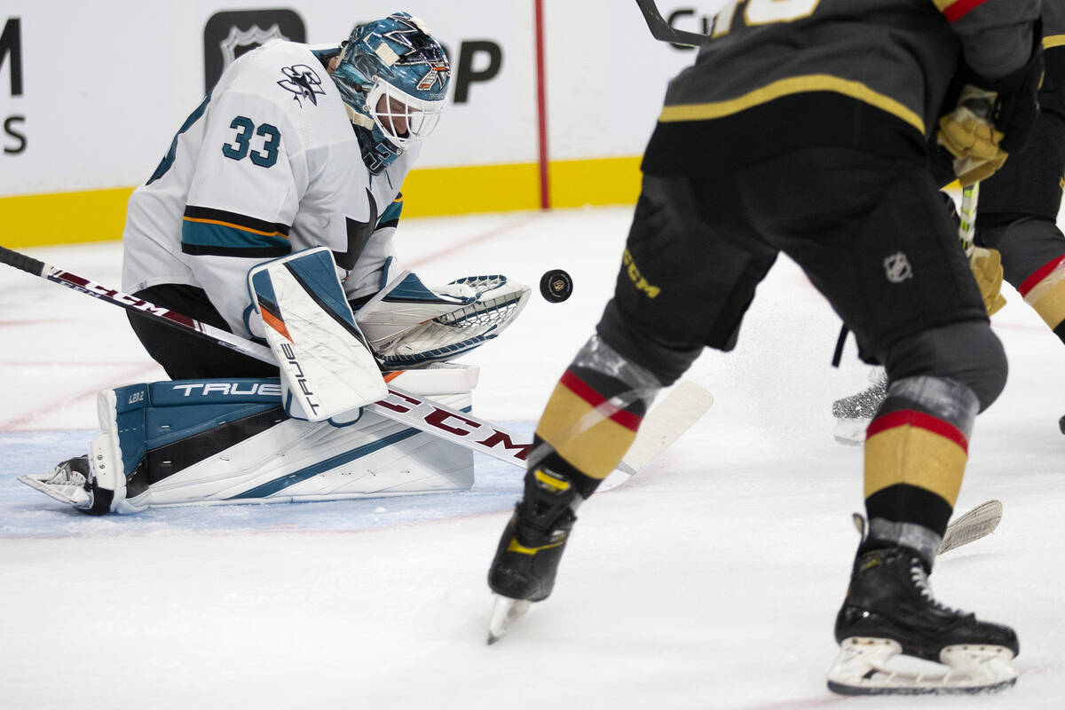 Sharks goaltender Adin Hill (33) saves a shot during the third period of a preseason NHL hockey ...