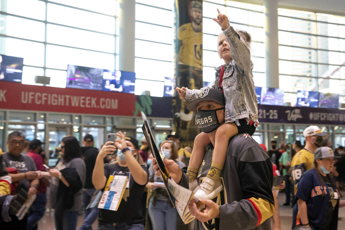 Lennon Wells, 3, sees the pre-game fan parade coming ahead as her father Jake Wells holds her b ...