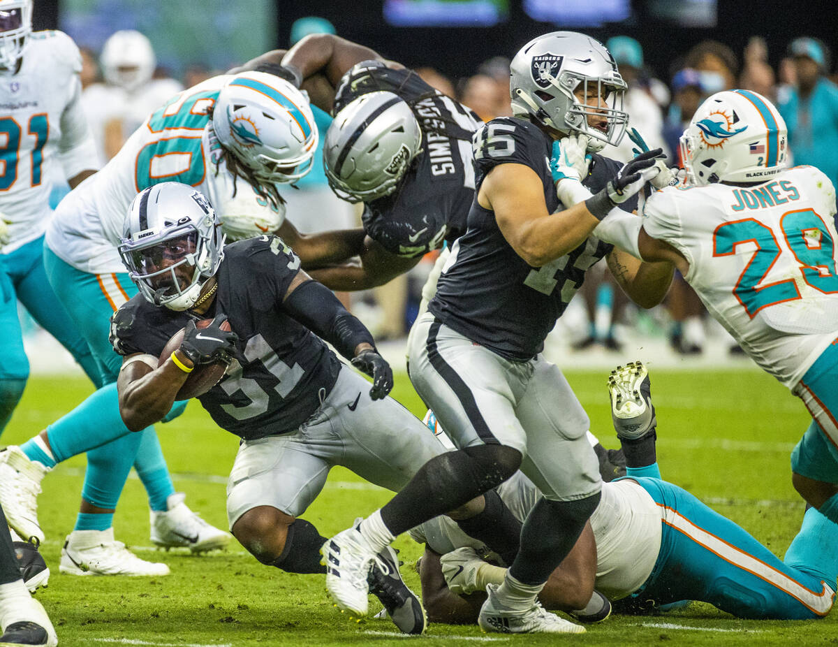 Las Vegas Raiders running back Peyton Barber (31) eyes the end zone on a run past Miami Dolphin ...