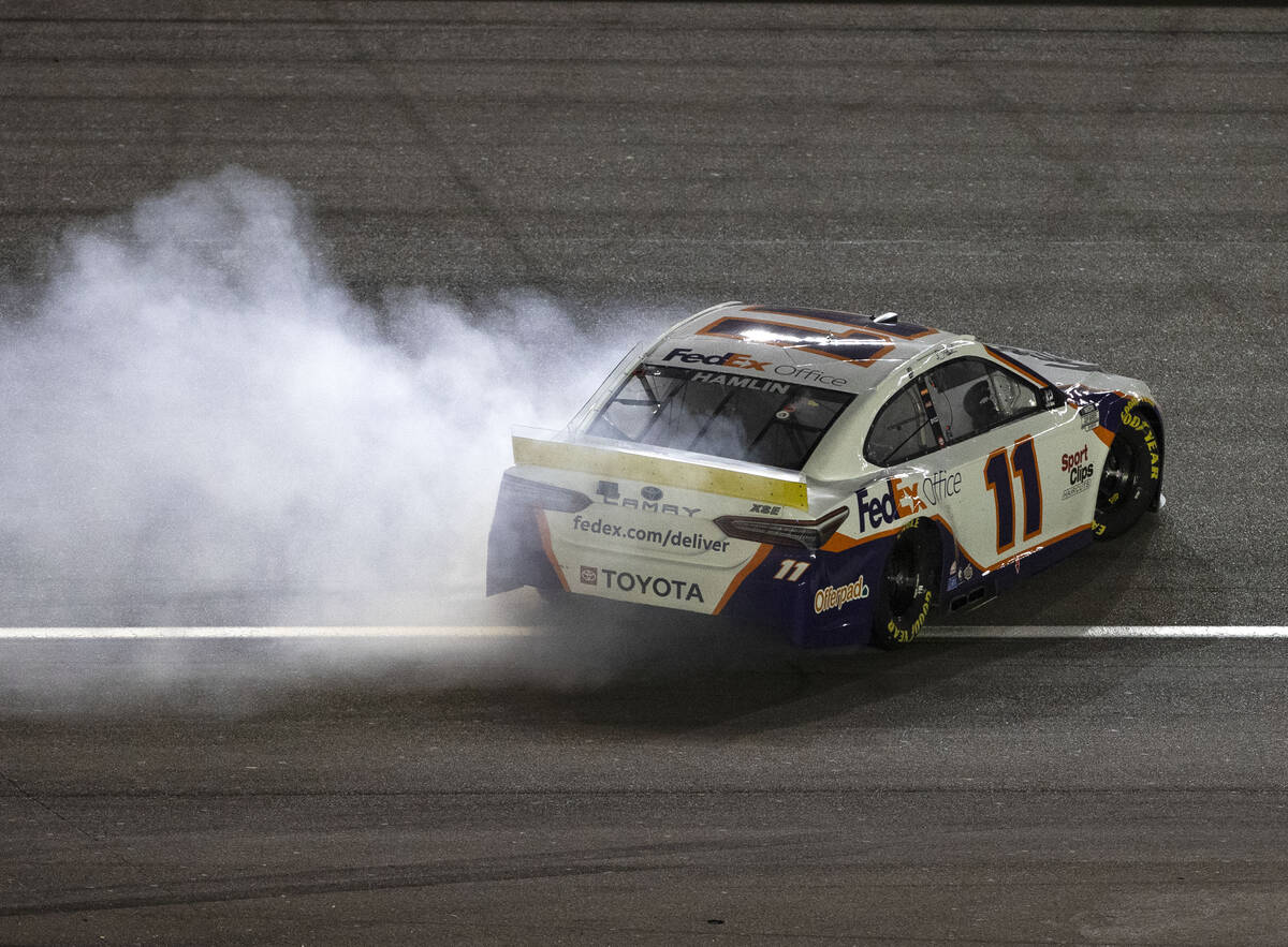 Denny Hamlin celebrates by spinning his number 11 after he won the 4th Annual South Point 400 a ...