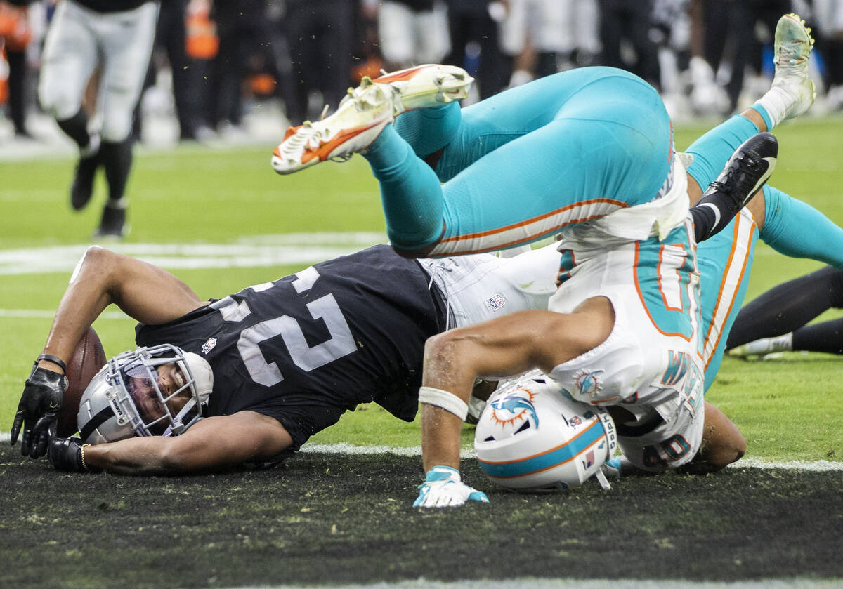 Las Vegas Raiders running back Kenyan Drake (23) reaches the ball into the end zone past Miami ...