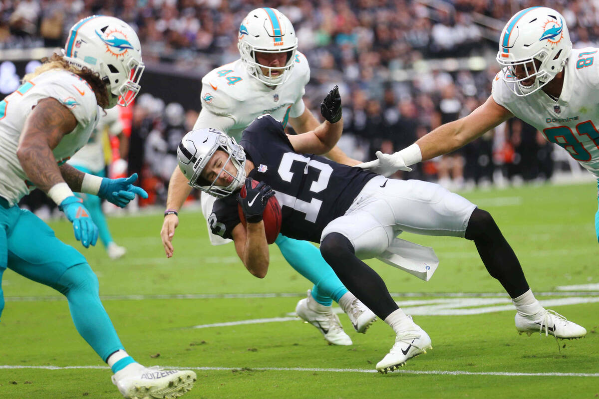 Las Vegas Raiders wide receiver Hunter Renfrow (13) drops to the ground during a punt to avoid ...