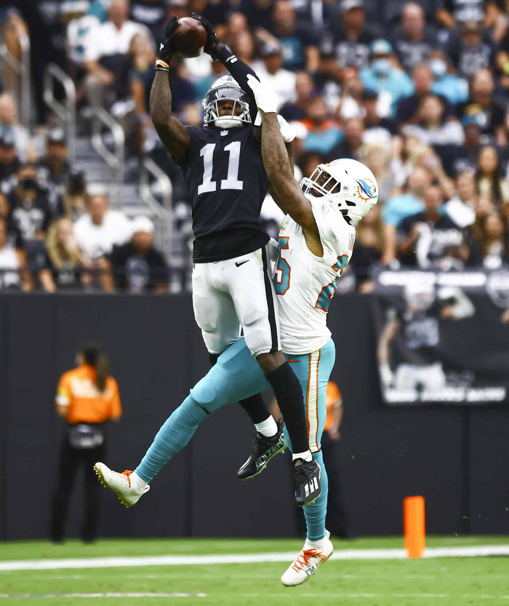 Las Vegas Raiders wide receiver Henry Ruggs III (11) goes up for a 23-yard pass under pressure ...