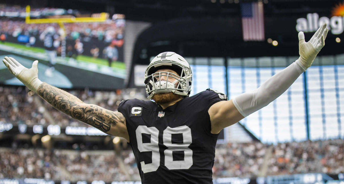 Las Vegas Raiders defensive end Maxx Crosby (98) salutes the crowd in the  first half during an …